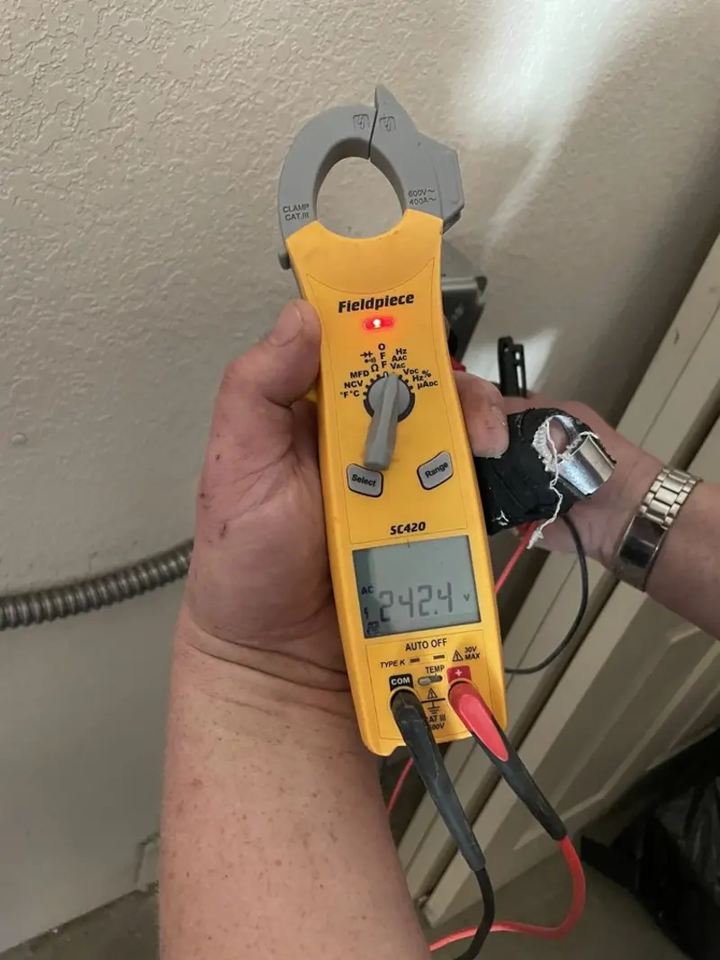 Voltage testing with clamp meter during Recessed Lighting Installation in Antigo